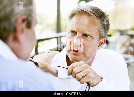 Friends having serious discussion Stock Photo