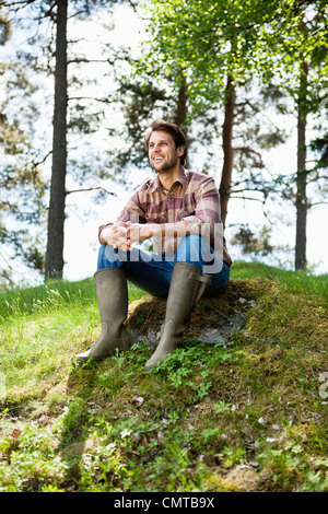 Smiling young man looking away Stock Photo