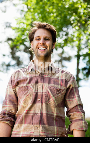 Young man looking at camera and smiling Stock Photo