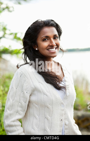 Portrait of smiling woman looking at camera Stock Photo