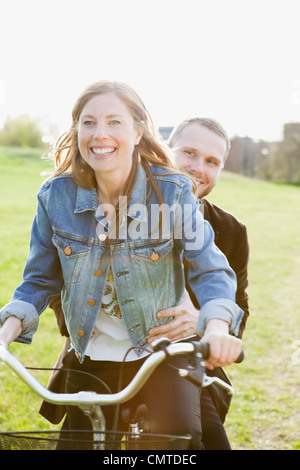 Happy couple riding bicycle Stock Photo