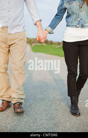 Couple holding hands while walking Stock Photo