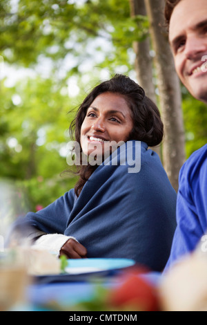 Smiling woman with man looking away Stock Photo
