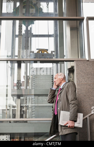 Man in stairs using cell phone Stock Photo