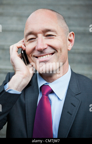 Happy businessman using cell phone Stock Photo
