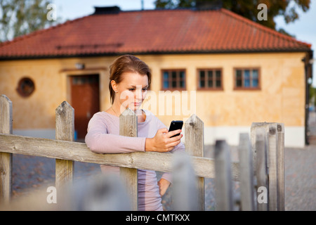 Woman looking at mobile phone Stock Photo