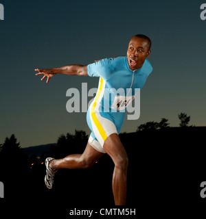Black runner crossing finish line in race Stock Photo