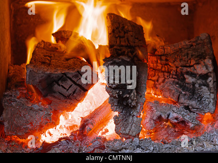 Fire in Fireplace with Firewood Stock Photo