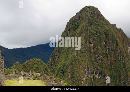 The mountain Huayna Picchu, or Wayna Picchu, which means Young Peak in Quechua, rises over the ruins of Machu Picchu, Peru Stock Photo