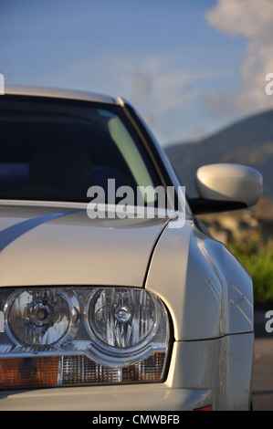 White car front side with nature view Stock Photo