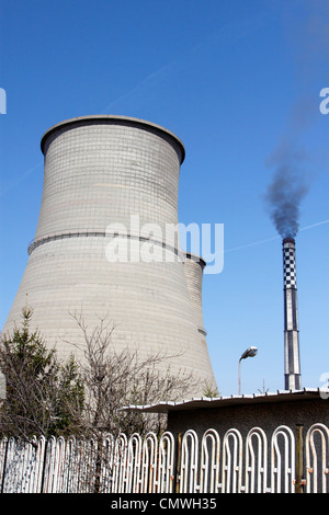 Cooling towers and chimney of Bobov Dol coal-fired power plant in western Bulgaria, black smoke coming out of the chimney Stock Photo