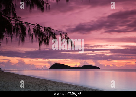 View along Palm Cove beach to Double Island at dawn. Palm Cove, Cairns, Queensland, Australia Stock Photo