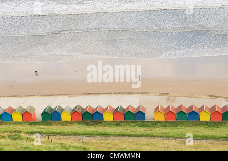 Row of beach huts by the shore at Whitby, North Yorkshire, England. Stock Photo
