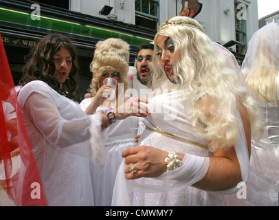 Men dressed up as brides outside a pub in Soho, following the Royal Wedding of William and Kate 2011 Stock Photo