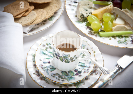 cup of expresso coffee with cheese and biscuits, laid out on a white linen tablecloth Stock Photo