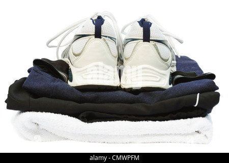 Gym kit with running shoes and towel, isolated against a white background with clipping path Stock Photo