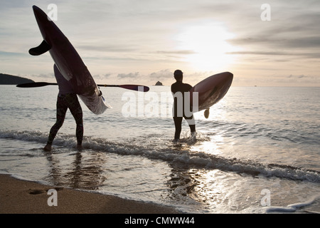 Group of kayakers heading out to sea at sunrise.  Palm Cove, Cairns, Queensland, Australia Stock Photo