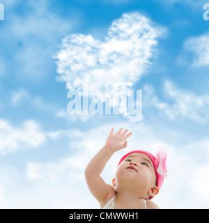 Baby girl hand towards sky Stock Photo