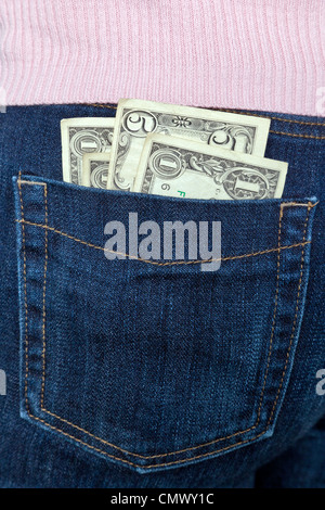 Photo of some US banknotes in the back pocket of a womans jeans. Stock Photo