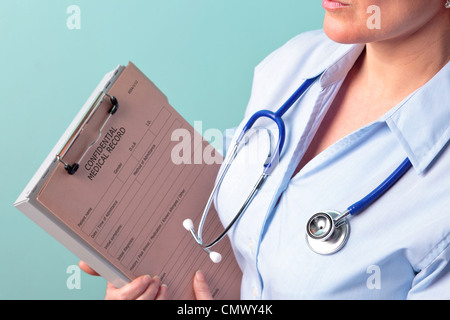 Photo of a female doctor holding a medical record Stock Photo