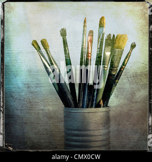 Paintbrushes in a tin, vintage look still life. Stock Photo