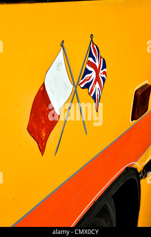 Flags on Old yellow bus, Malta, Mediterranean, Europe Stock Photo