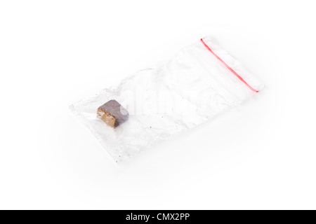 Piece of hashish in pocket closeup on white Stock Photo