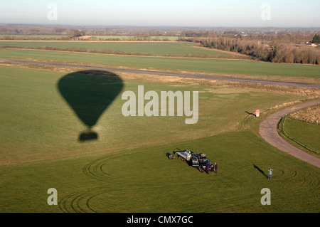 Shadow of Virgin hot air balloon on the ground just after taking off from Old Buckenham airfield, Norfolk, UK Stock Photo