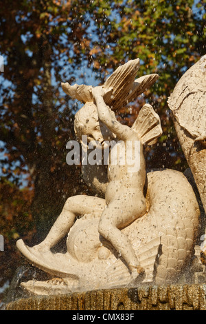 Madrid, Spain. Detail of a cherub on the Los Galapagos fountain in El Retiro gardens. Stock Photo