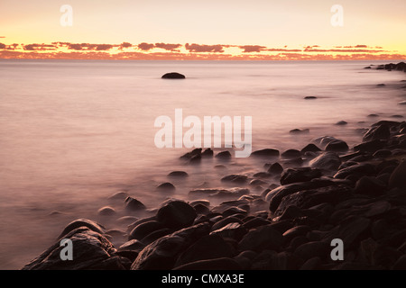 Dawn over the Coral Sea at Pebbly Beach, near Cairns, Queensland, Australia Stock Photo