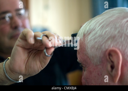 London Ontario, Canada - March 28, 2012. Vincenzo Ioele of 'Vince's Barber Shop' looks after regular customer George Stovel. Stock Photo