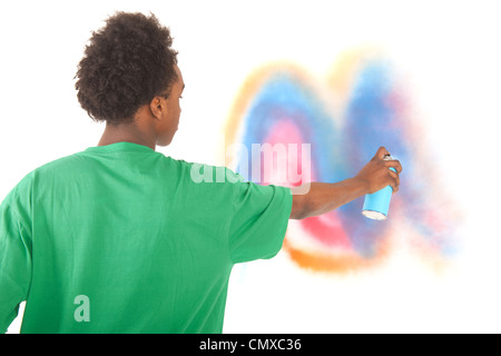 Black teenager is making graffiti art with paint aerosol Stock Photo