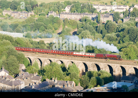 Steam locomotive pulling a passenger train on the mainline at Slaithwaite viaduct, West Yorkshire Stock Photo