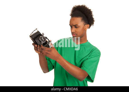 teenager boy is looking to old vintage photo camera Stock Photo