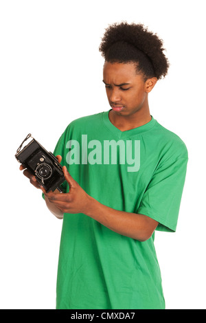 teenager boy is looking to old vintage photo camera Stock Photo