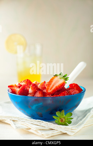 Strawberry Fruit Salad in a Blue Bowl with Lemonade Stock Photo