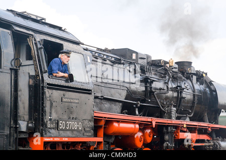 German steam locomotive at Hilbersdorf Steam Shed near Chemnitz, Germany with the engine driver Stock Photo