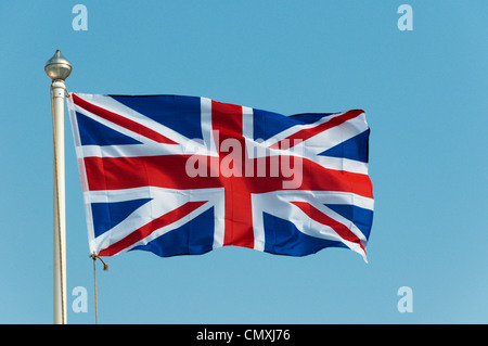 A Union Jack flag flying against a blue sky Stock Photo - Alamy