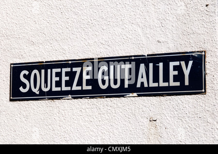 The street name sign for Squeeze Gut Alley in Whitstable, Kent. Stock Photo