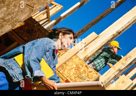 Female construction boss and male worker(, tradesman,) at site. Stock Photo