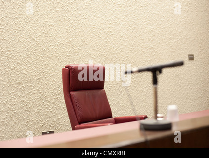 The judges chair behind the desk and microphone in a room in the sheriff court house Stock Photo