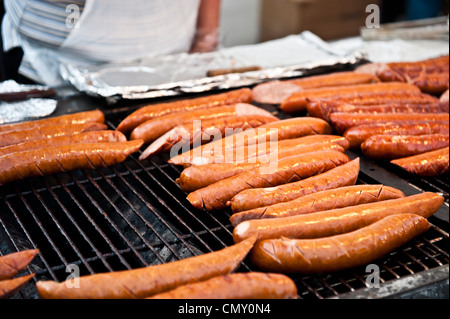 Bratwurst cooking on a grill. Stock Photo