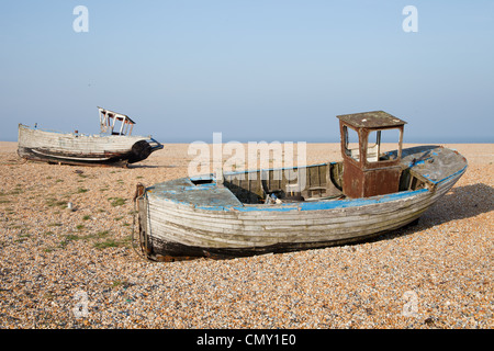 Two old fishing boats in bad condition after years of neglect on the beach at Dungeness, Kent, UK. Stock Photo