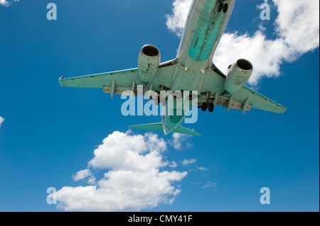 A large airplane landing on a remote island for a vacation. Stock Photo