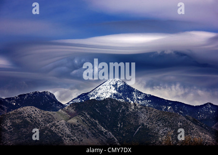 Strange (lenticular) cloud, over Mavrovouna, one of the highest summits of Taygetos mountain. Peloponnese, Greece. Stock Photo