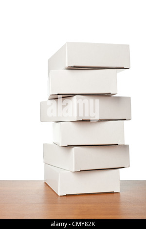 Stack of white boxes on a table against white background Stock Photo