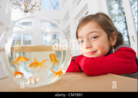 Germany, Bavaria, Grobenzell, Girl with goldfish bowl, smiling, portrait Stock Photo