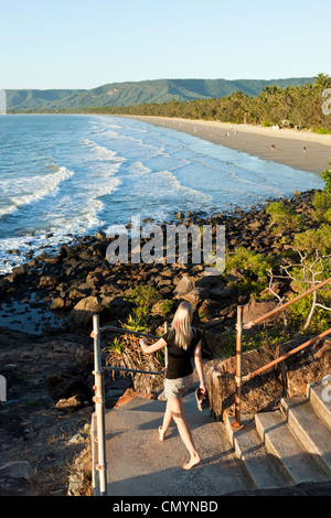 Woman walking coastal path at Four Mile Beach. Port Douglas, Queensland, Australia Stock Photo