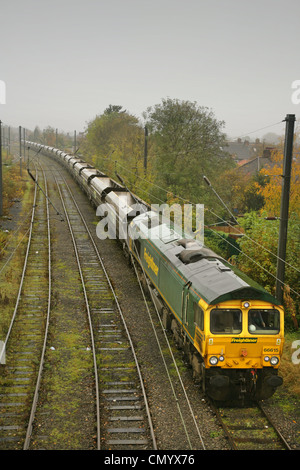 Class 66 diesel locomotive 66615 with train of empty coal wagons, waiting in Holgate sidings south of York station. Stock Photo