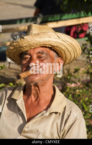 Old Man with cigar in front of village church, Vinales Valley, Province Pinar del Rio, Cuba, Greater Antilles, Antilles, Carribe Stock Photo